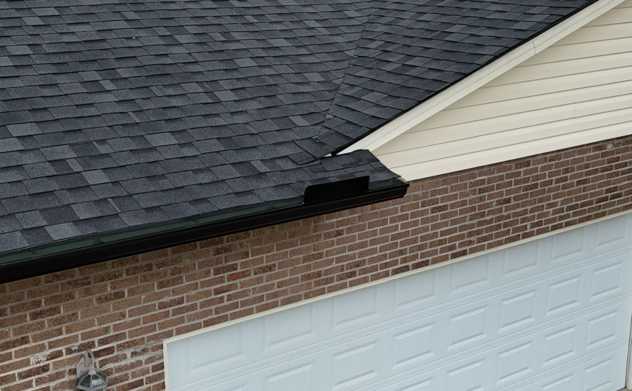 Seamless Black Gutter on Brick Home